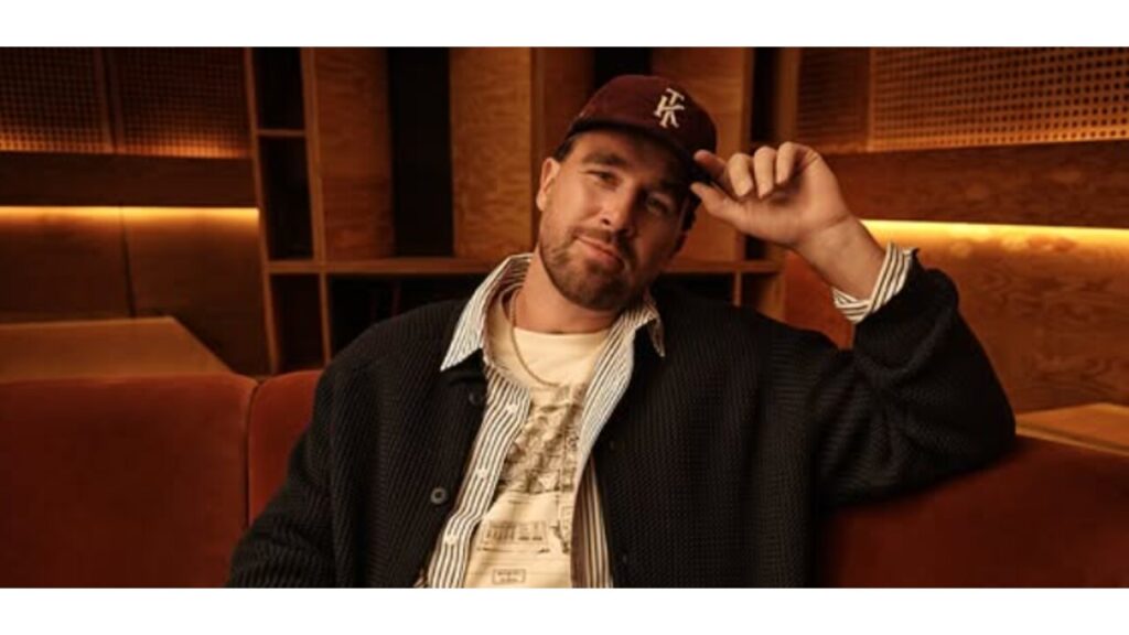 Travis Kelce sitting on a couch.