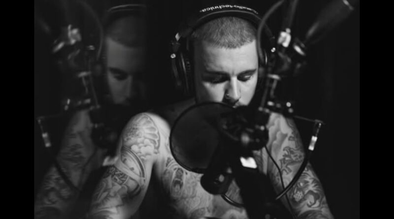 Justin Bieber recording on microphone.