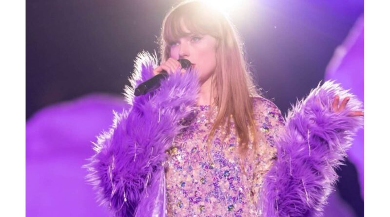 Taylor Swift holding a mic close to her mouth.