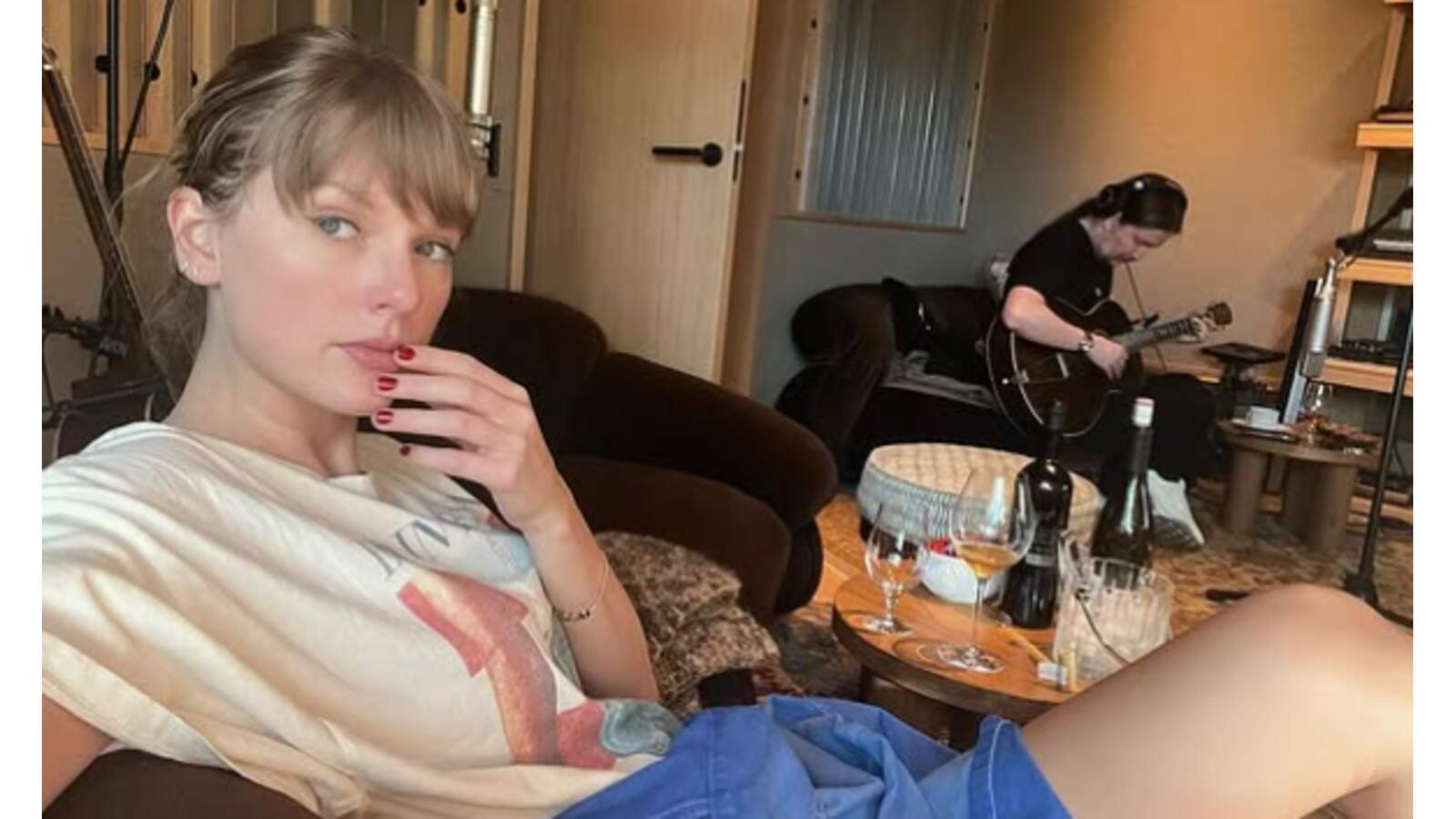 Taylor Swift sitting in a studio.