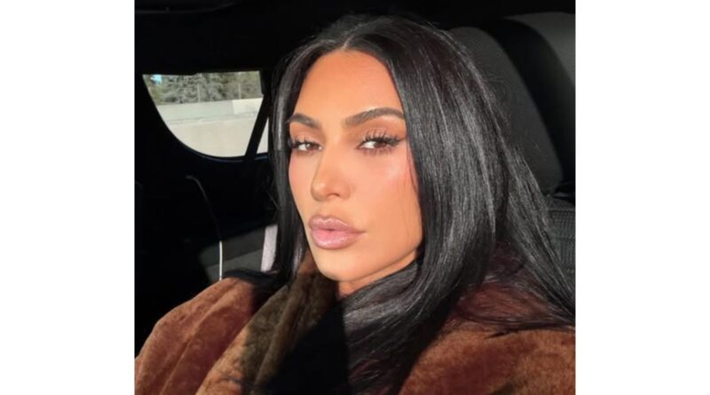 Kim Kardashian taking selfie in car.