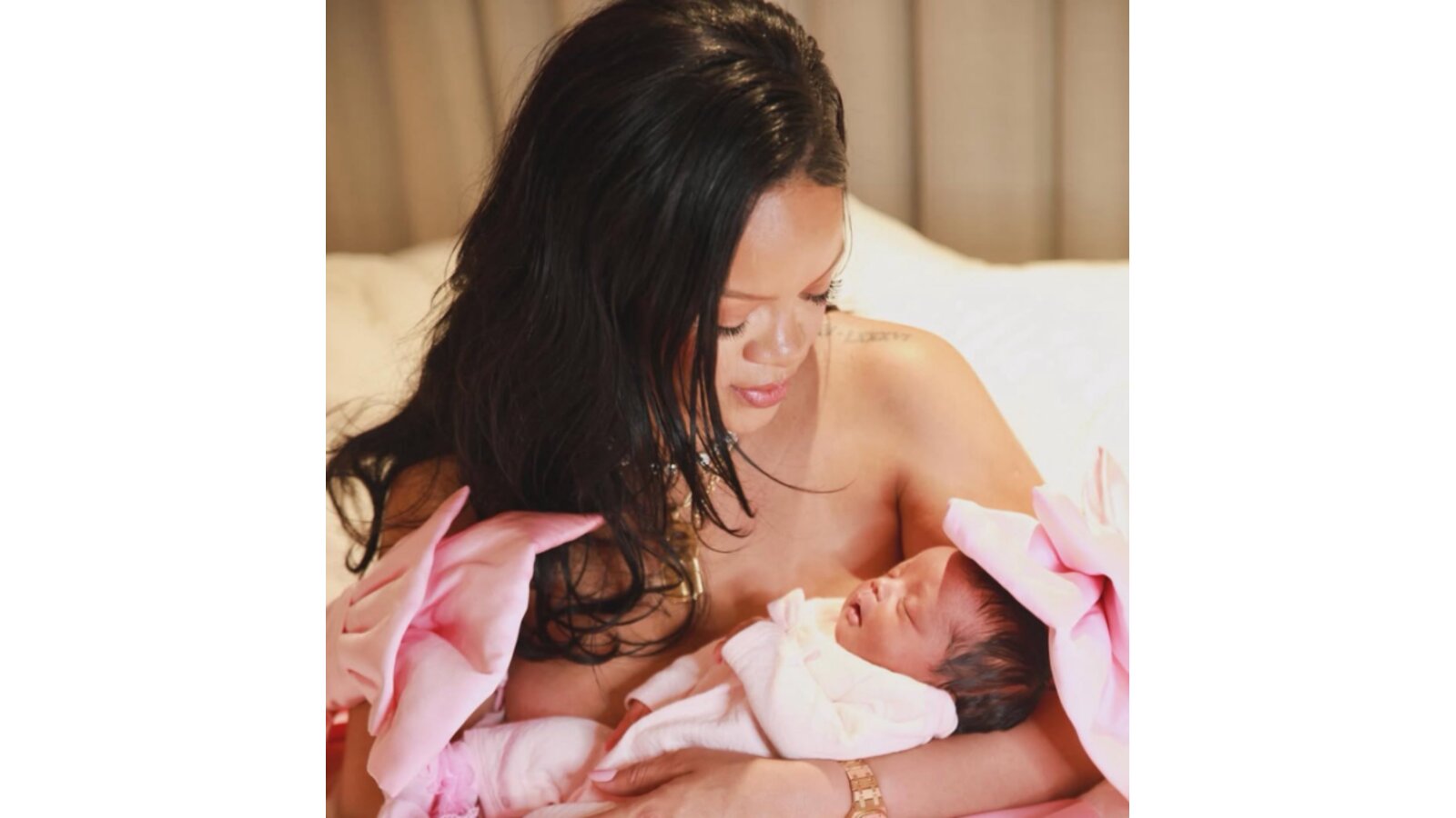 Rihanna holding her baby girl.