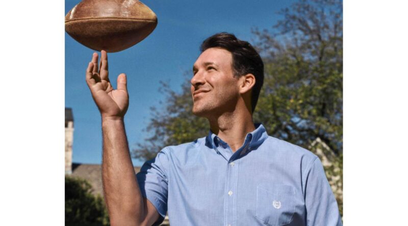 Tony Romo playing with a football.