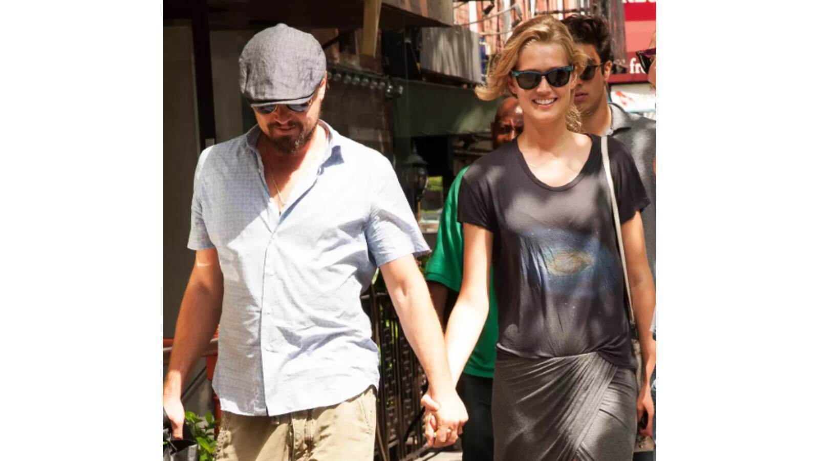 Leonardo DiCaprio and Toni Garrn holding hands.