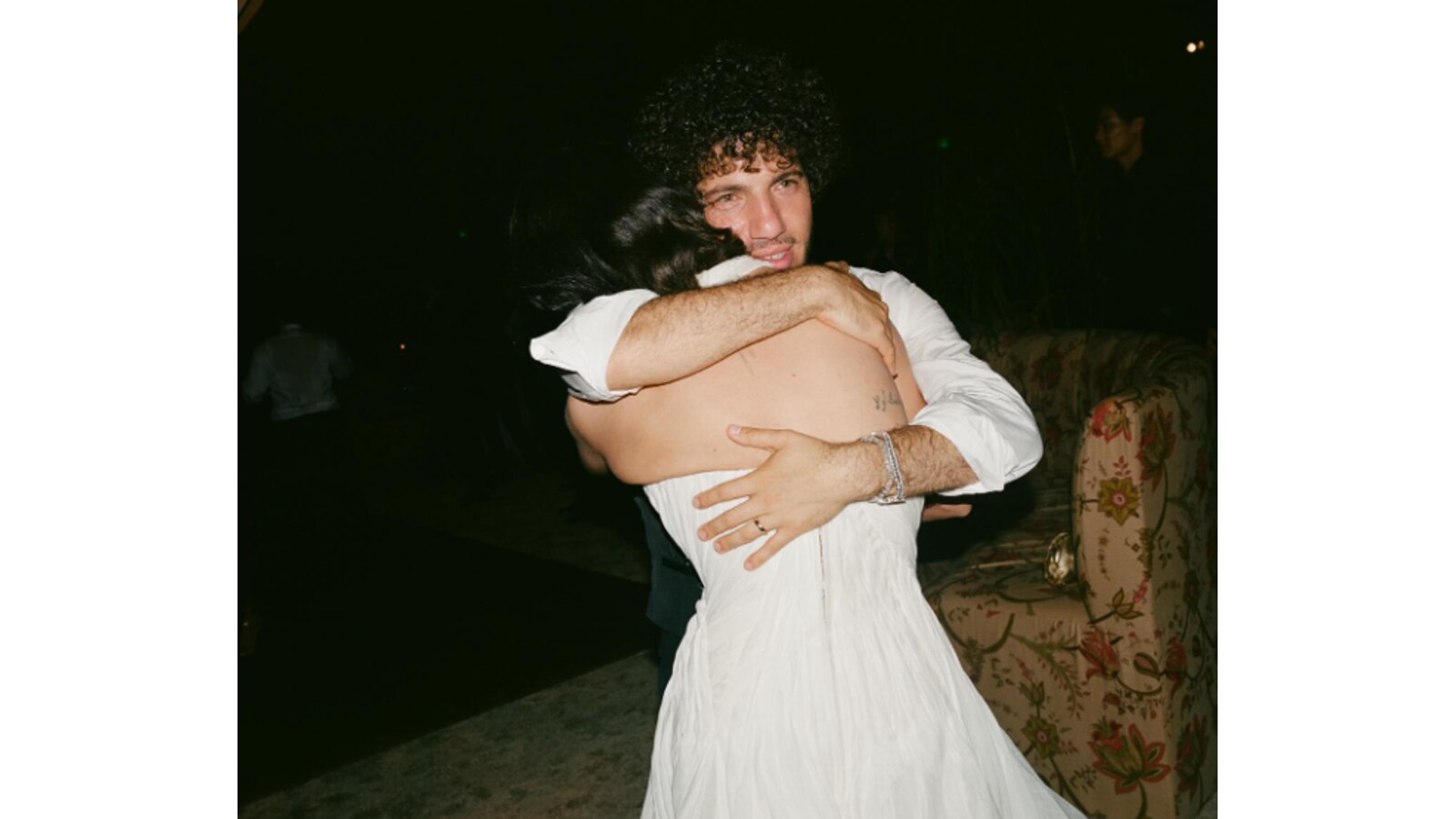 Benny Blanco hugging Selena Gomez.